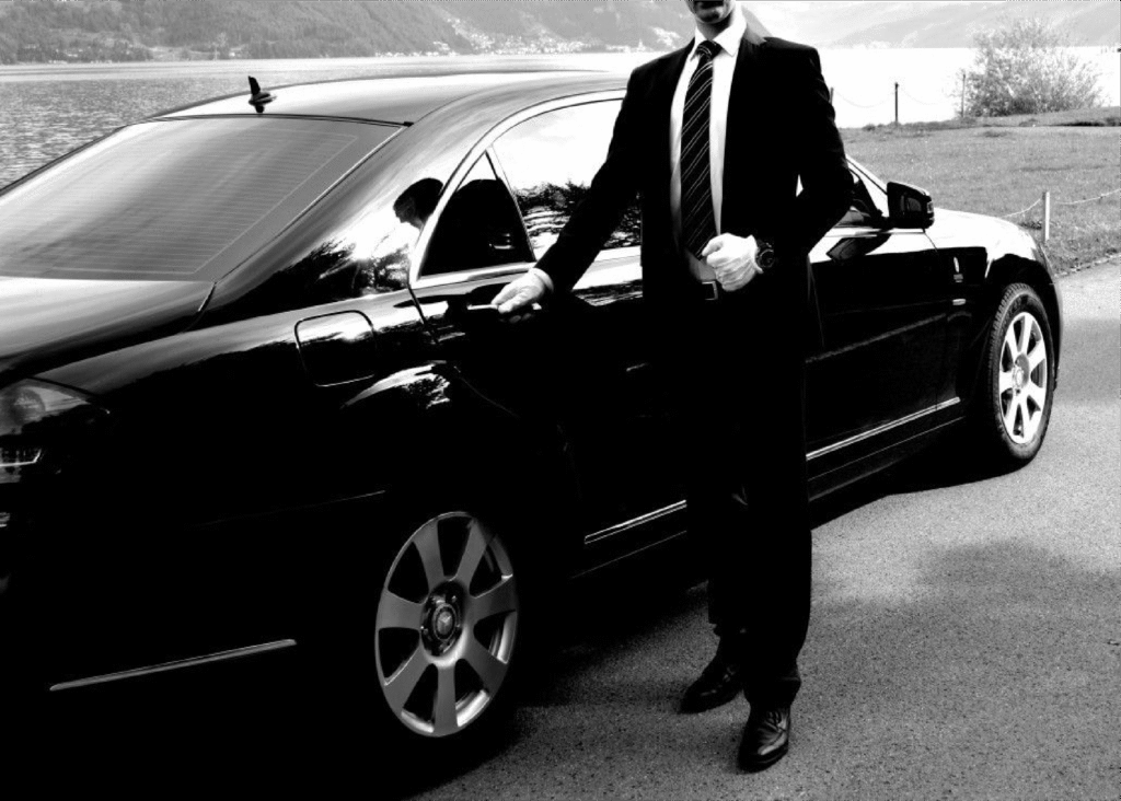 Chauffeur opening luxury car door in Dubai – Best Safe Driver Company in Dubai professional service